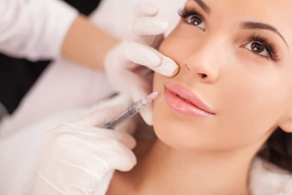A brunette woman getting a Botox injection.