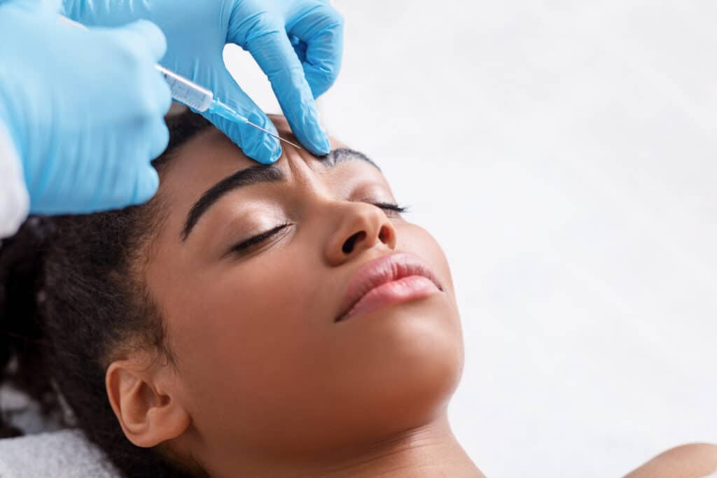 An African American woman getting a Dysport injection.