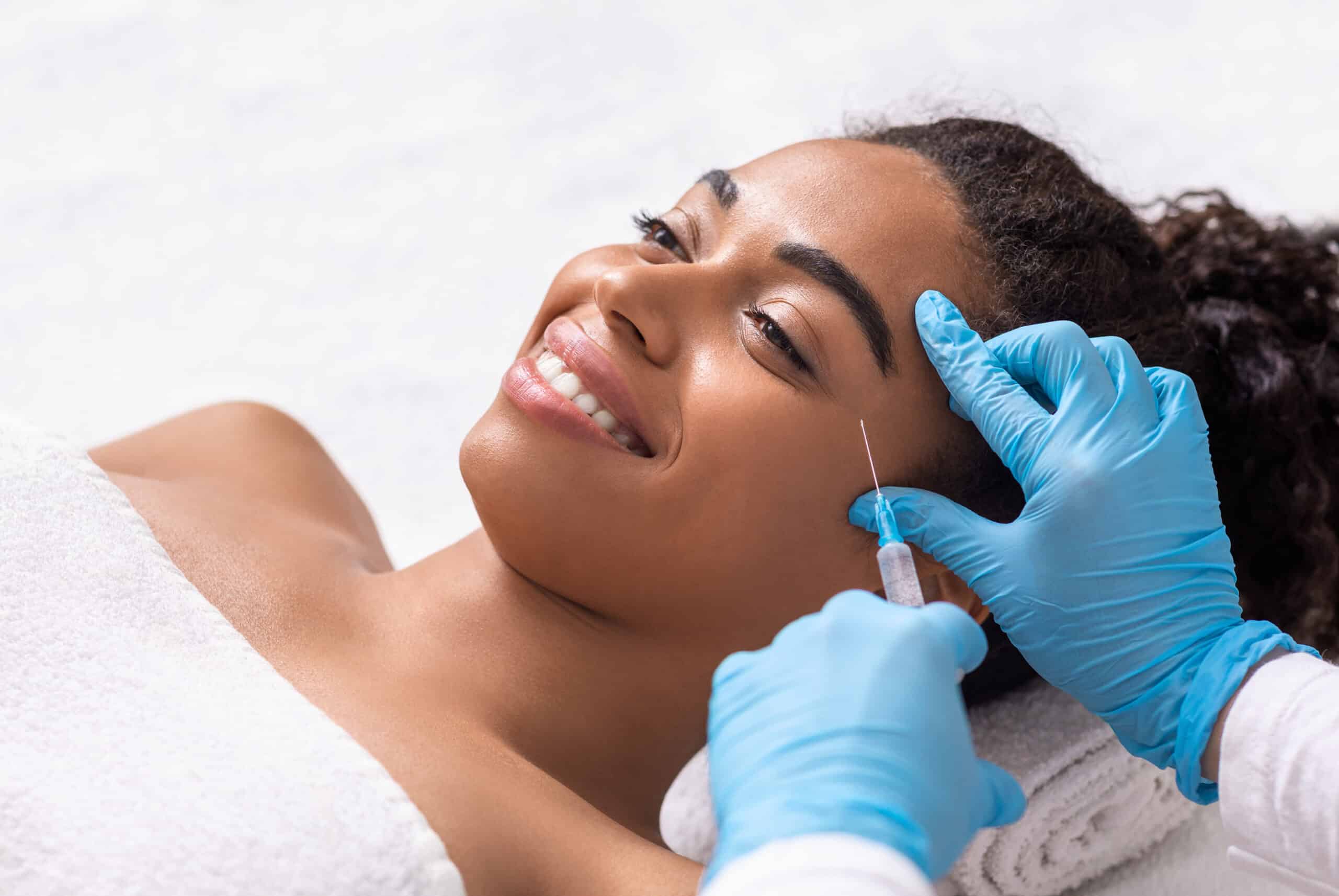 An African American woman getting a Dysport injection.